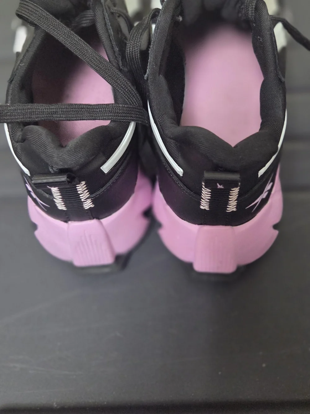 Reebok Black Athletic Sneakers with White Stripes and Pink Logo
